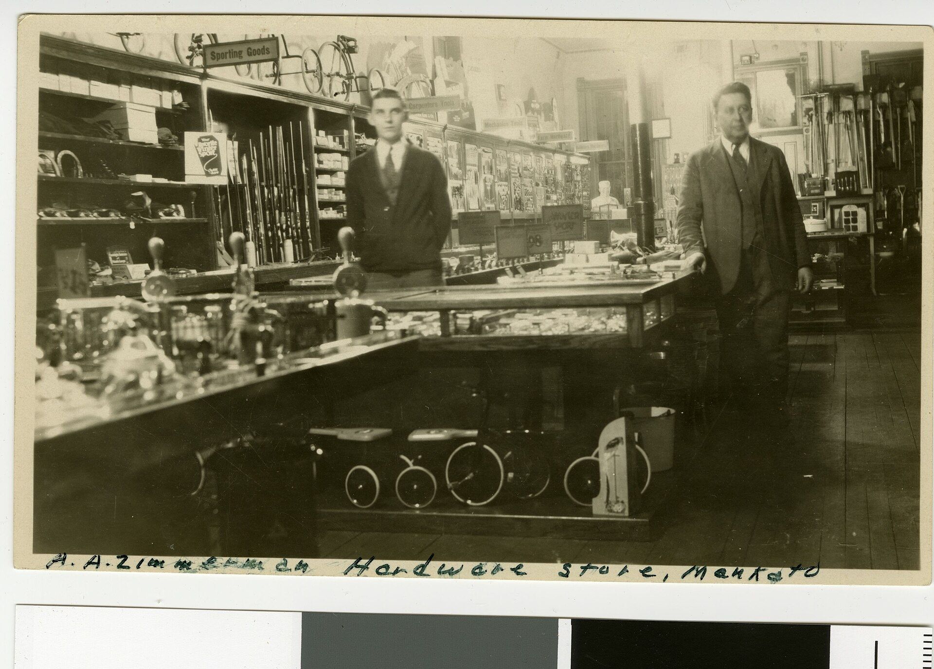 The interior of a family hardware store of the early twentieth century with goods stacked. A Wikimedia Commons photograph on Brent O'Mara Insights.