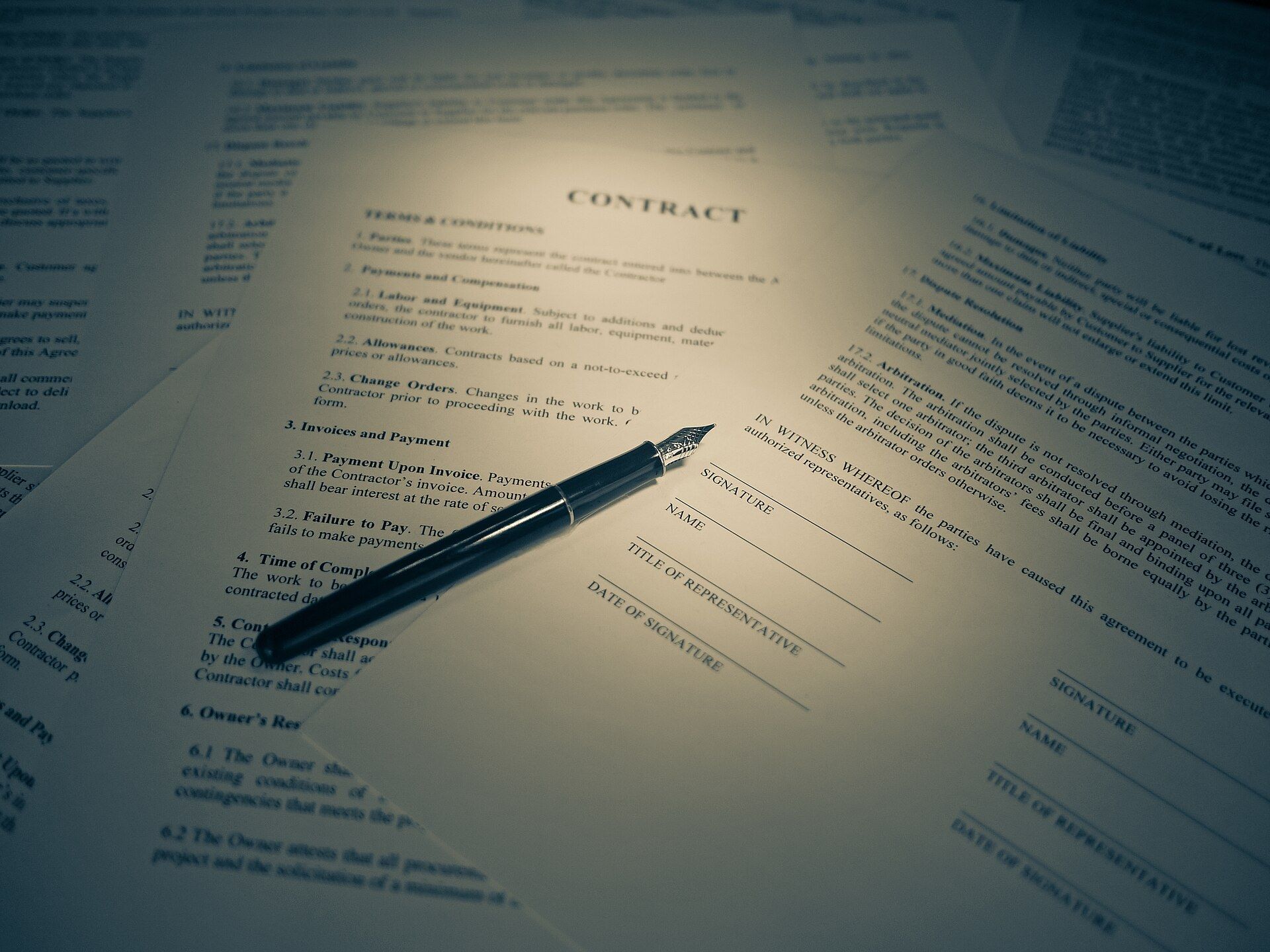 A pen resting on the signature line of a printed legal agreement. A Wikimedia Commons photograph on Brent O'Mara Insights.