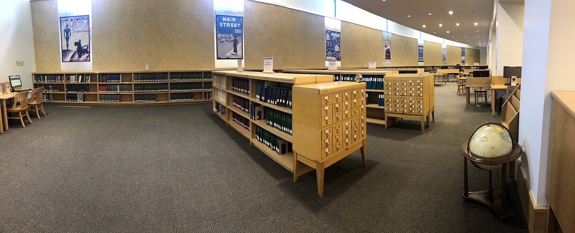 A long reading room with tables and shelves in a history center library. A Wikimedia Commons photograph on Brent O'Mara Insights.