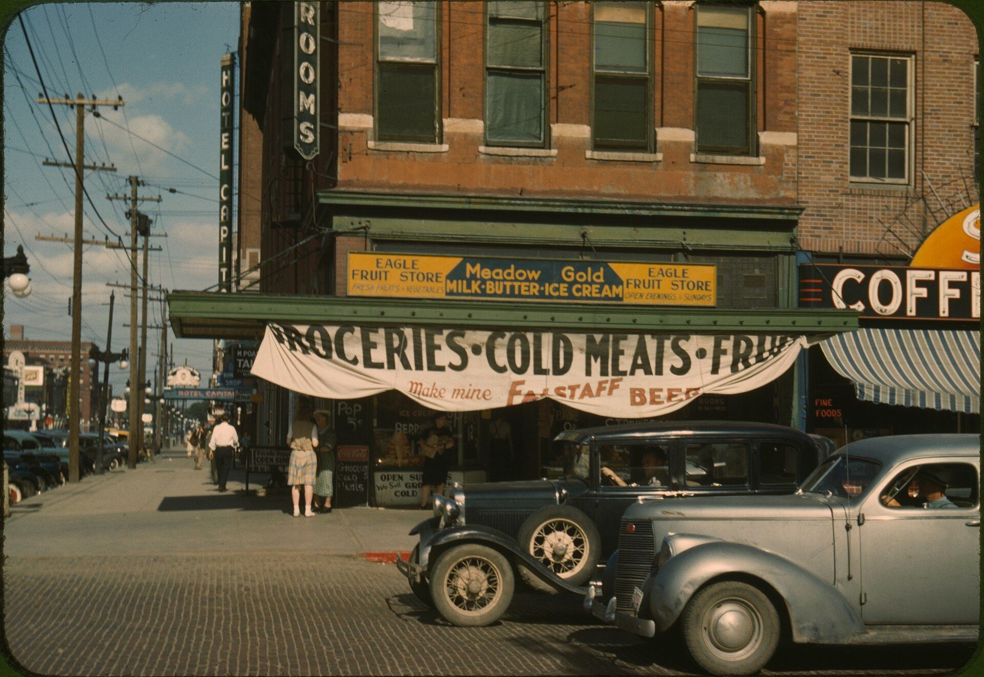 A fruit store front in Lincoln Nebraska in the 1940s with its prices posted. A Wikimedia Commons photograph on Brent O'Mara Insights.