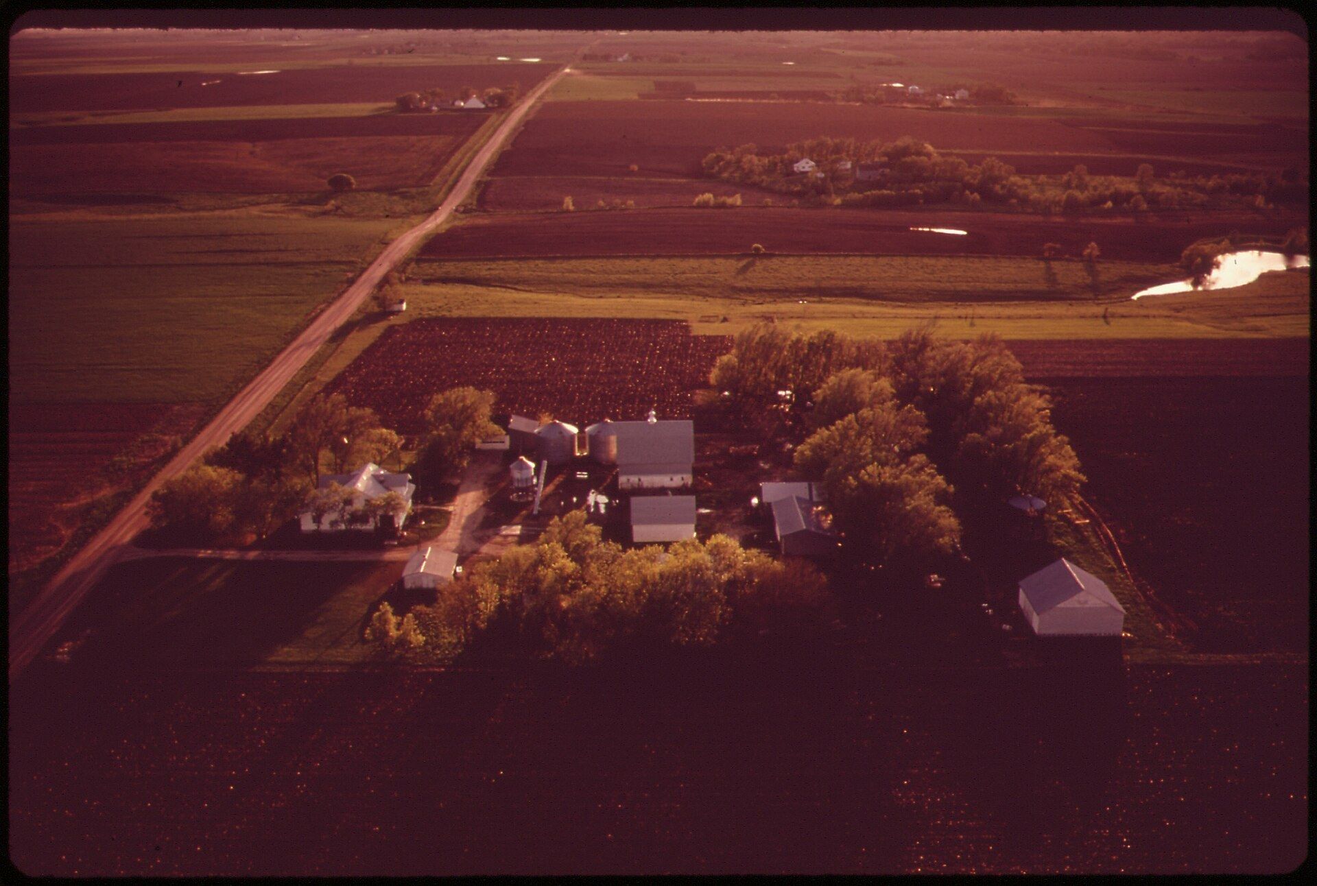 Farm fields west of Lincoln seen from the air in a patchwork of crops and section roads. A Wikimedia Commons photograph on Brent O'Mara Insights.