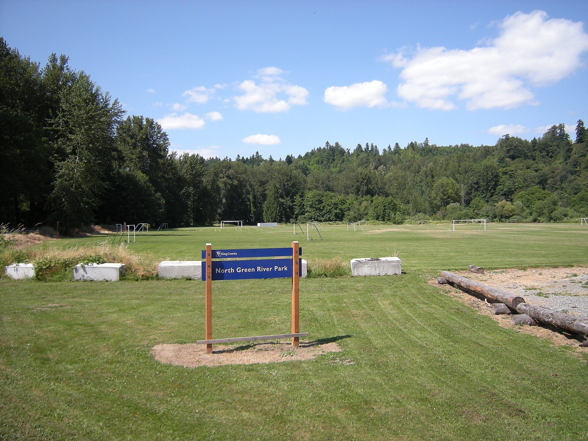 Empty grass soccer fields with goals waiting under an overcast sky. A Wikimedia Commons photograph on Brent O'Mara Insights.