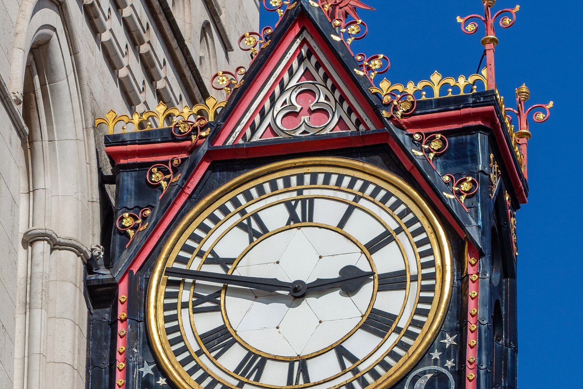 An ornate clock mounted on the corner of a stone court building. A Wikimedia Commons photograph on Brent O'Mara Insights.