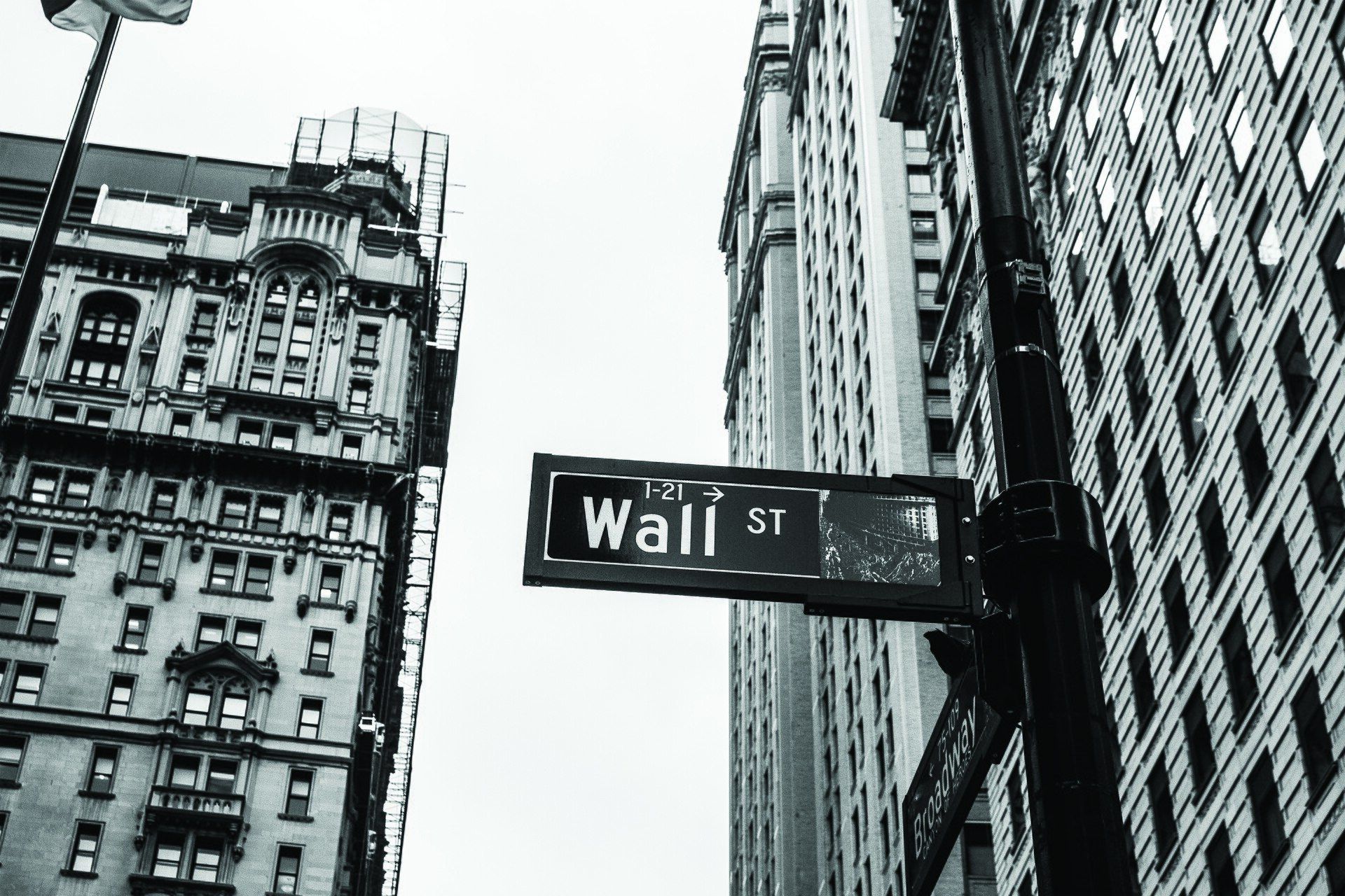 A Wall Street street sign photographed in black and white. A Wikimedia Commons photograph on Brent O'Mara Insights.