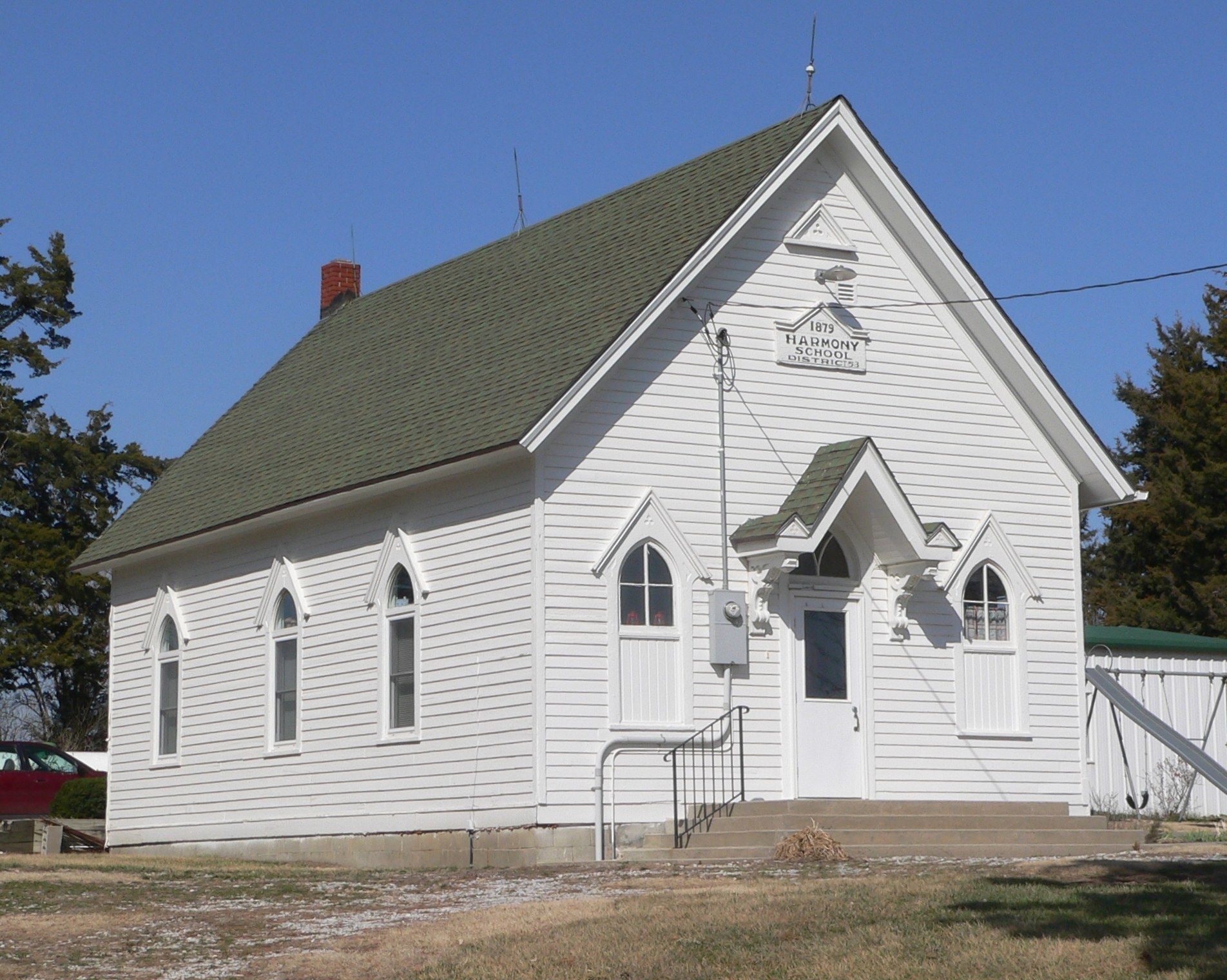 A white one room schoolhouse standing in a Nebraska field. A Wikimedia Commons photograph on Brent O'Mara Insights.