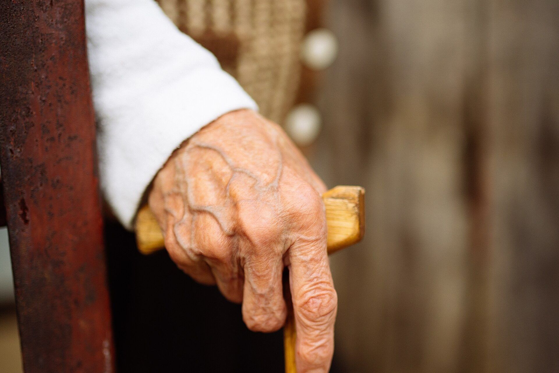 An older person's hands resting on the handle of a wooden cane. A Wikimedia Commons photograph on Brent O'Mara Insights.