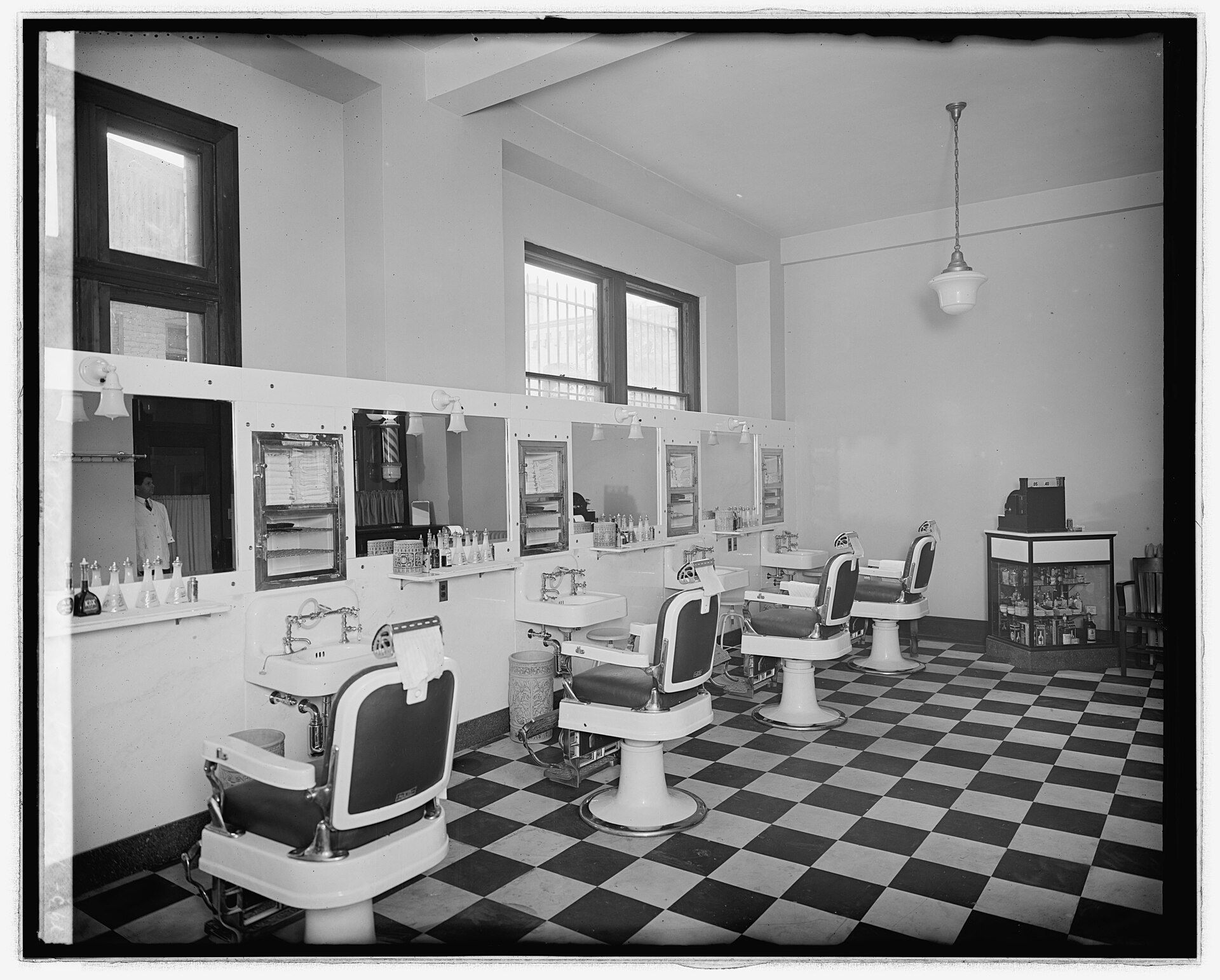 An empty barber shop of the 1920s with its row of chairs and mirrors. A Wikimedia Commons photograph on Brent O'Mara Insights.