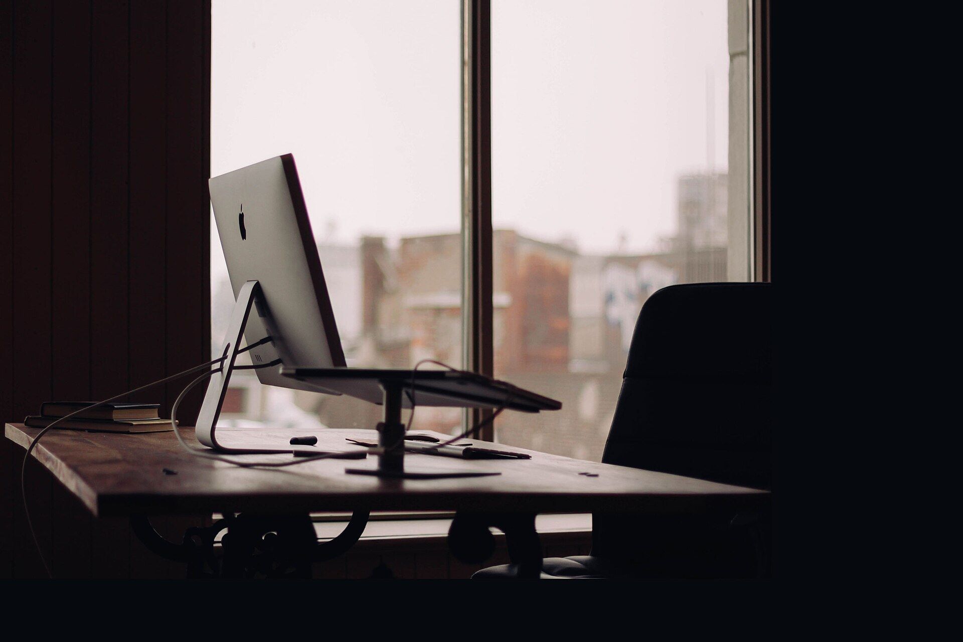 A tidy desk by a window with a notebook and a lamp. A Wikimedia Commons photograph on Brent O'Mara Insights.